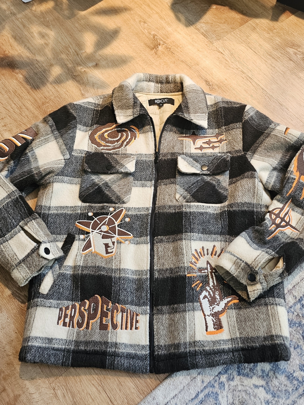 Focus plaid graphic jacket size Medium, embroidered patches and a quilted Liner